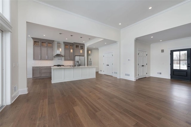 unfurnished living room with dark wood-style flooring, recessed lighting, visible vents, ornamental molding, and baseboards