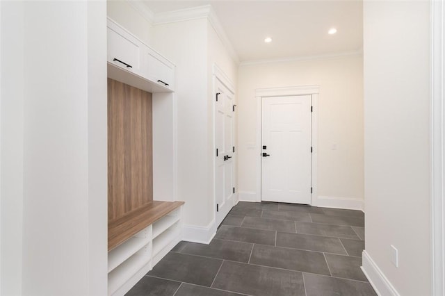 mudroom featuring dark tile patterned flooring, crown molding, baseboards, and recessed lighting