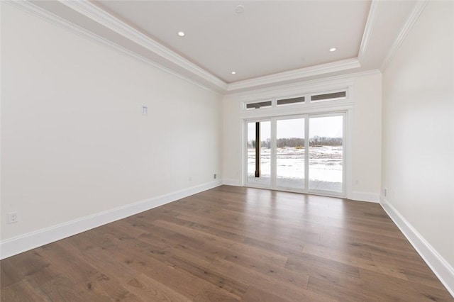 unfurnished room featuring baseboards, crown molding, and wood finished floors