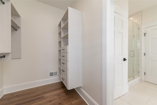 spacious closet featuring visible vents and wood finished floors