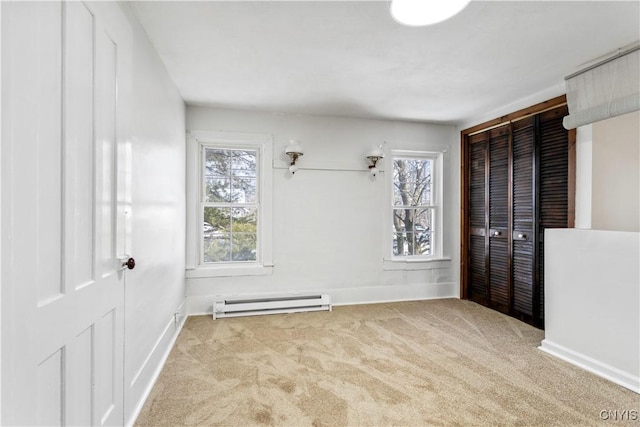 interior space featuring a wealth of natural light, baseboards, baseboard heating, and carpet flooring