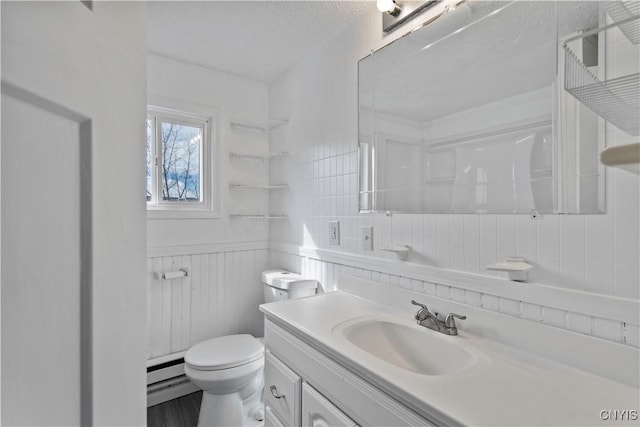 bathroom with a wainscoted wall, a textured ceiling, vanity, and toilet