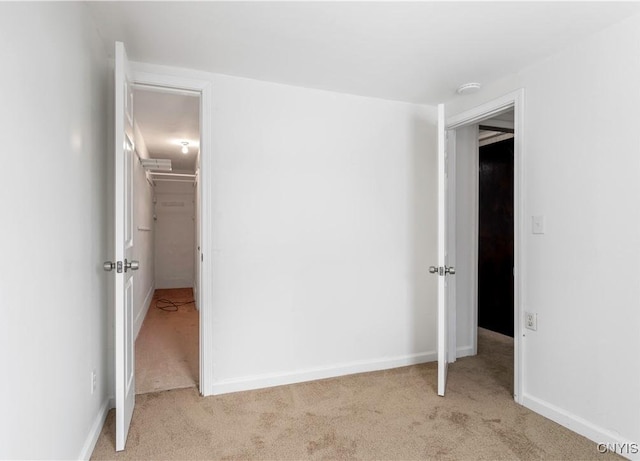 unfurnished bedroom with carpet and baseboards