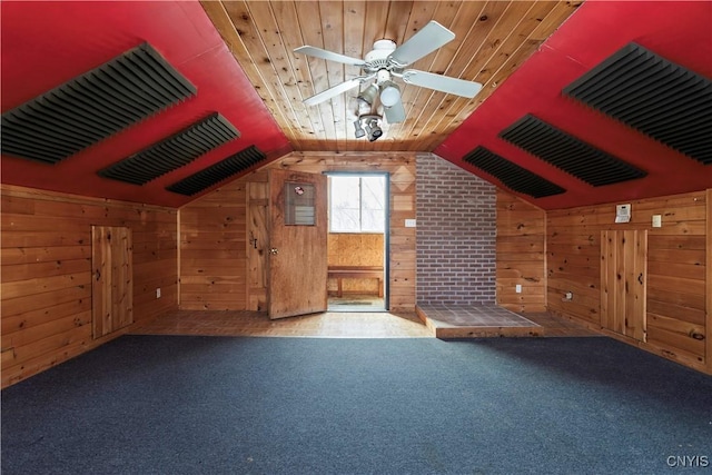 bonus room featuring wooden walls, carpet flooring, a ceiling fan, wood ceiling, and vaulted ceiling