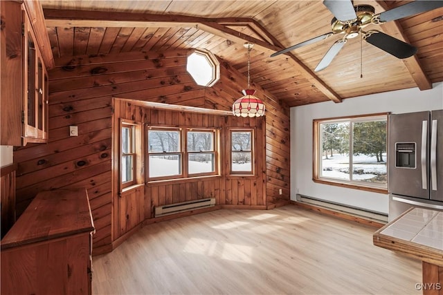 interior space featuring lofted ceiling with beams, a baseboard radiator, tile counters, and stainless steel fridge with ice dispenser