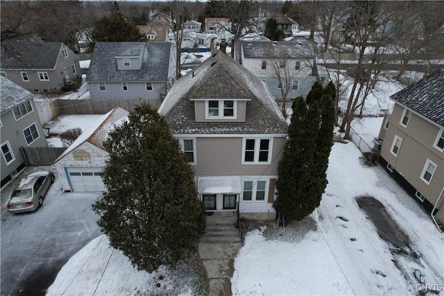 snowy aerial view with a residential view