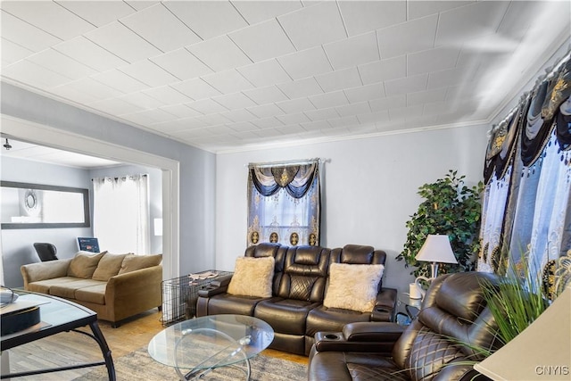 living room with light wood-style floors and ornamental molding