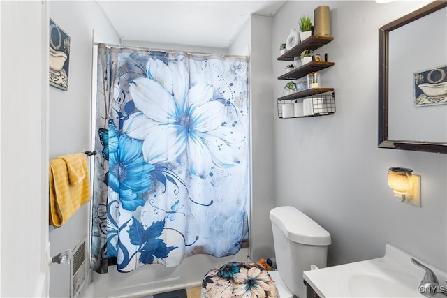 full bath featuring toilet, shower / bath combo with shower curtain, and a sink