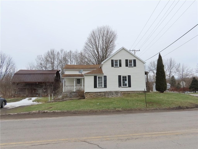 traditional-style house with driveway, an attached carport, and a front yard