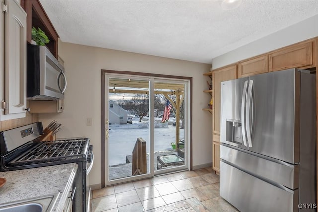 kitchen featuring open shelves, a textured ceiling, stainless steel appliances, and light countertops