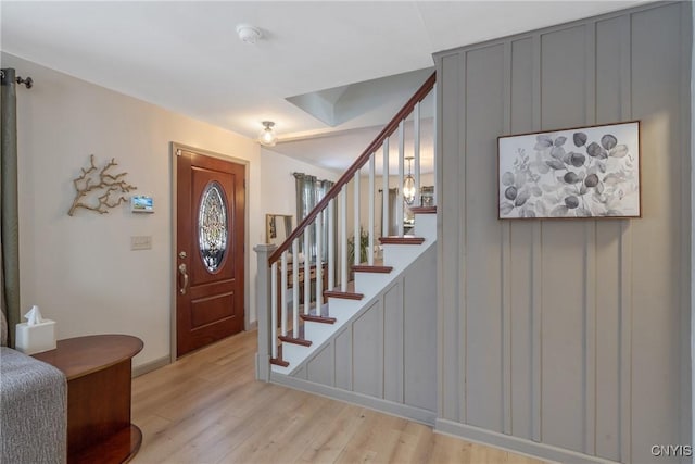 entryway featuring stairway and light wood-style floors