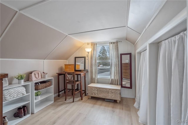 additional living space featuring lofted ceiling and wood finished floors