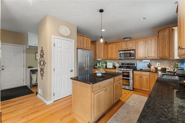 608 Lynhurst Ave, Horseheads, NY 14845 - kitchen with decorative backsplash, a kitchen island, a sink, stainless steel appliances, and light wood-style flooring