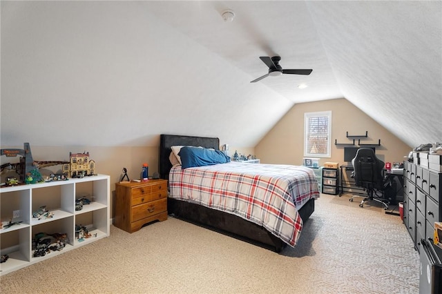 carpeted bedroom with vaulted ceiling and a ceiling fan