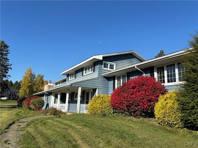 exterior space with a porch and a lawn