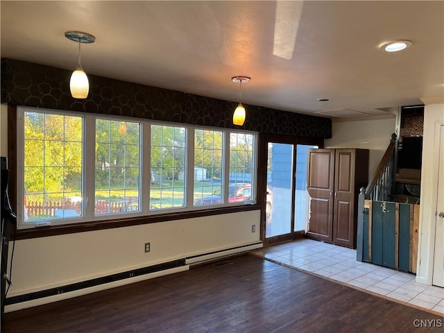 interior space featuring light wood-type flooring, stairs, and baseboard heating