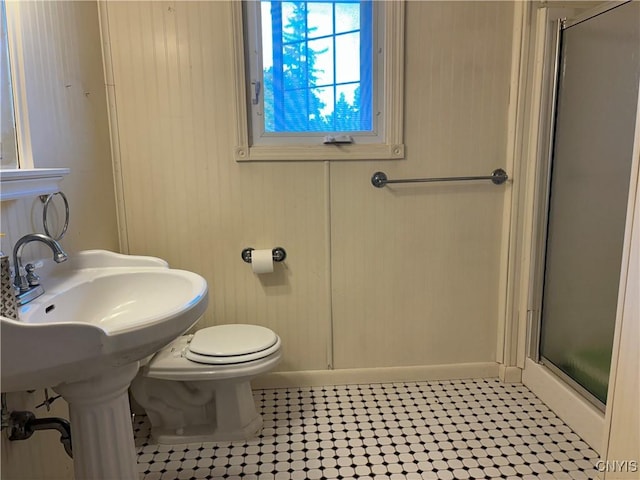 bathroom featuring a shower stall and toilet