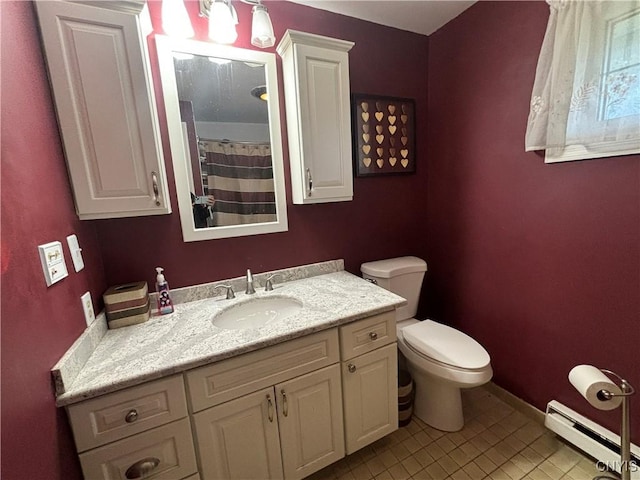 bathroom with toilet, baseboard heating, vanity, tile patterned flooring, and baseboards