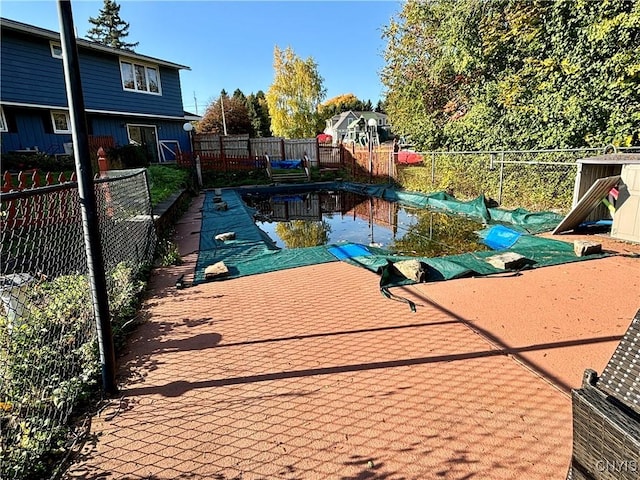 view of swimming pool with a fenced backyard