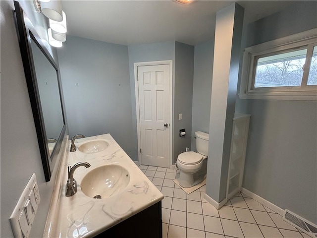 full bath with visible vents, a sink, toilet, and tile patterned floors