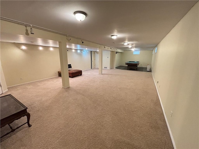 finished below grade area with pool table, carpet flooring, rail lighting, and baseboards