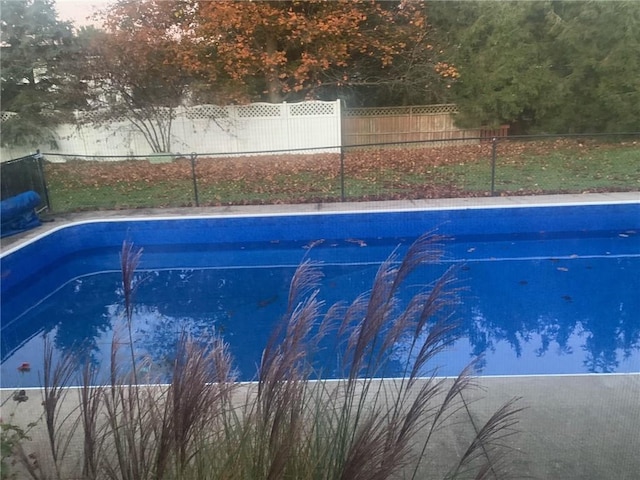 view of swimming pool featuring a fenced backyard and a fenced in pool