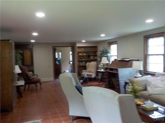 living area featuring recessed lighting, tile patterned flooring, and crown molding