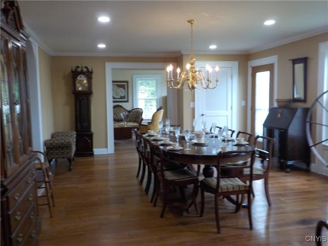 dining space with ornamental molding, a chandelier, wood finished floors, and recessed lighting