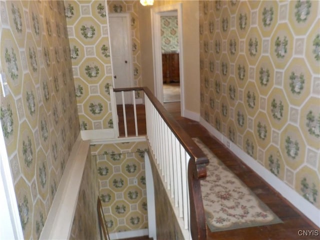 hallway featuring tile patterned flooring and baseboards