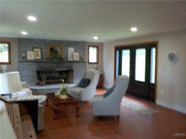 tiled living area featuring recessed lighting and a fireplace