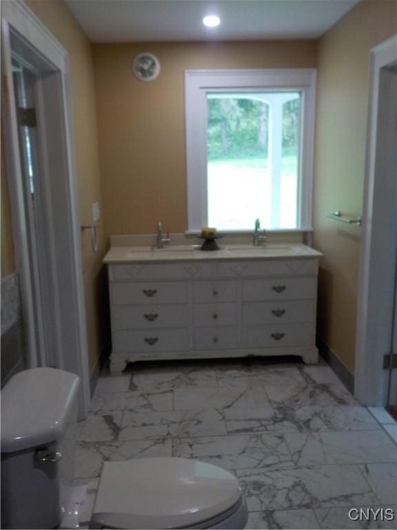 bathroom featuring marble finish floor, a sink, and toilet