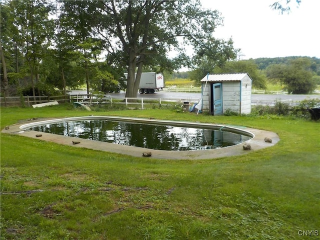 surrounding community featuring a storage shed, fence, an outdoor structure, and a yard