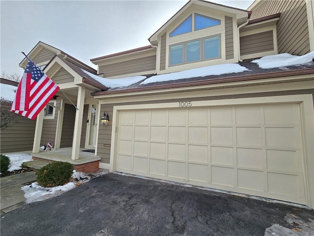 view of front of home featuring a garage and aphalt driveway