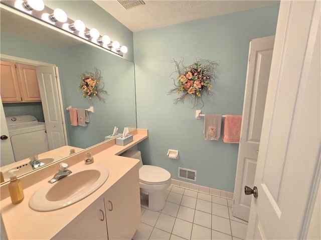 bathroom featuring toilet, washer / dryer, tile patterned flooring, and visible vents