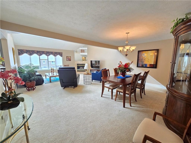 1005 Hillsboro Cove Cir, Webster, NY 14580 - dining room featuring an inviting chandelier, a textured ceiling, carpet, and a glass covered fireplace
