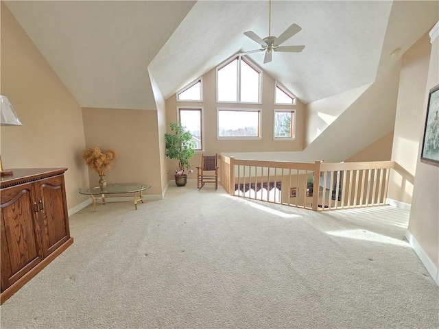 bonus room featuring high vaulted ceiling, carpet flooring, a ceiling fan, and baseboards