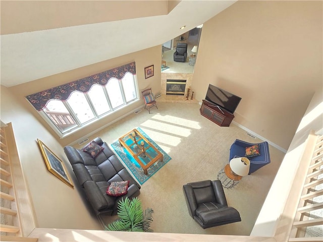 carpeted living room with visible vents and a fireplace