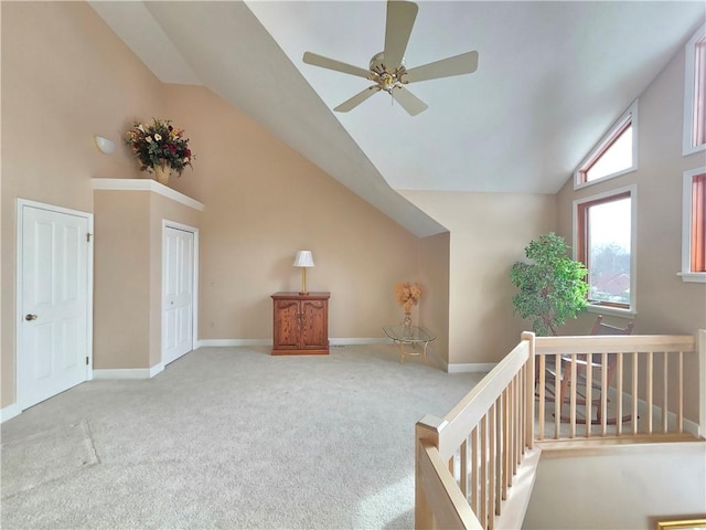 additional living space with high vaulted ceiling, carpet flooring, and baseboards