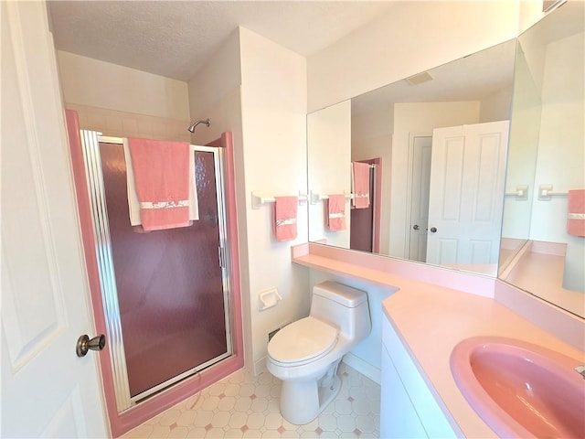 bathroom with a stall shower, toilet, tile patterned floors, a textured ceiling, and vanity