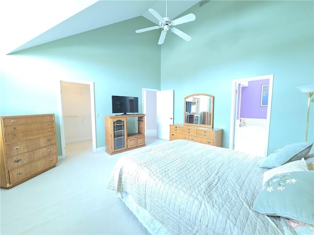 carpeted bedroom featuring baseboards, a ceiling fan, a walk in closet, high vaulted ceiling, and a closet