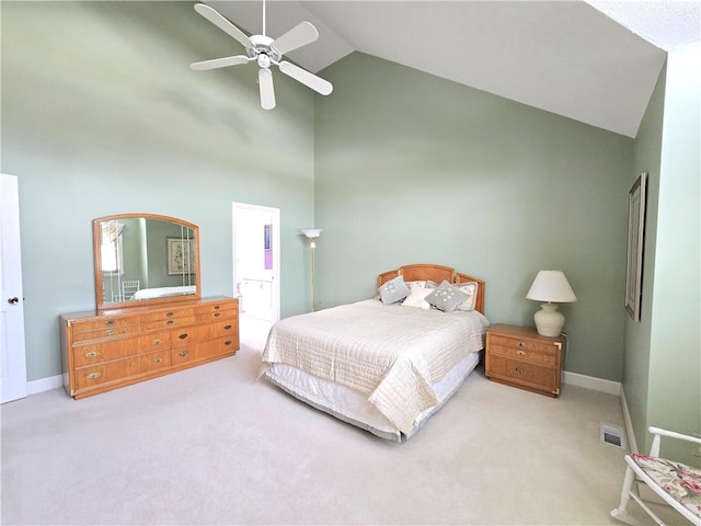 carpeted bedroom featuring baseboards, visible vents, a ceiling fan, ensuite bath, and high vaulted ceiling