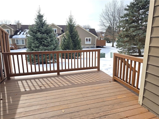 snow covered deck with a residential view