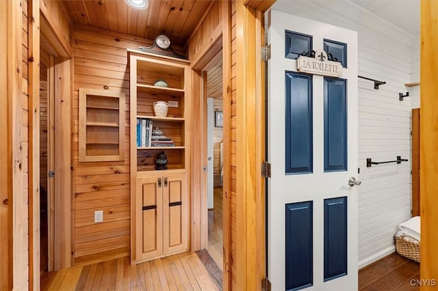 23000 County Route 57, Lyme, NY 13693 - hallway featuring light wood-style flooring, wood walls, and wooden ceiling