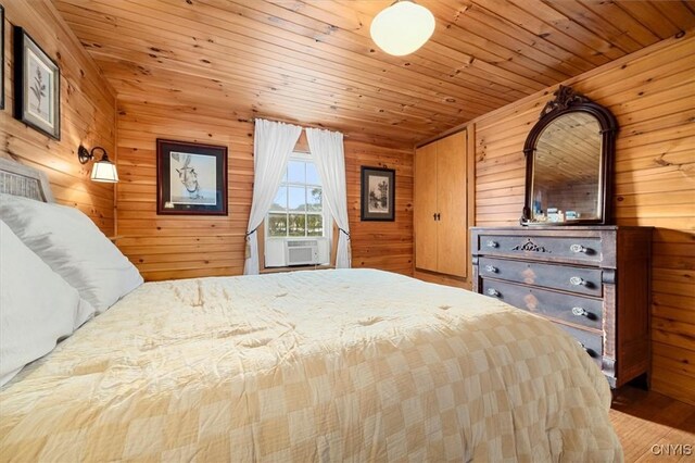 23000 County Route 57, Lyme, NY 13693 - bedroom with wooden walls, wood ceiling, wood finished floors, and cooling unit