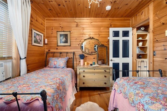 23000 County Route 57, Lyme, NY 13693 - bedroom featuring wood finished floors, wooden ceiling, and wooden walls