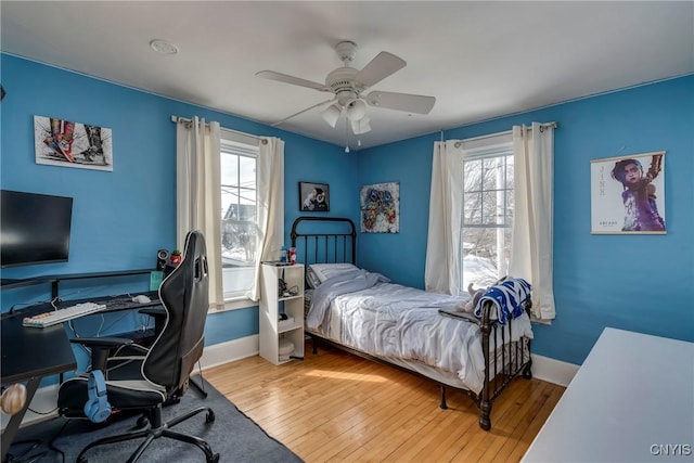 bedroom with wood-type flooring, baseboards, and ceiling fan