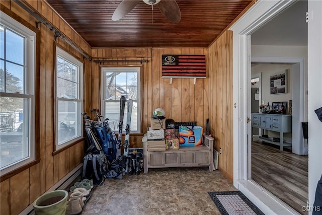 sunroom / solarium featuring a ceiling fan and wood ceiling