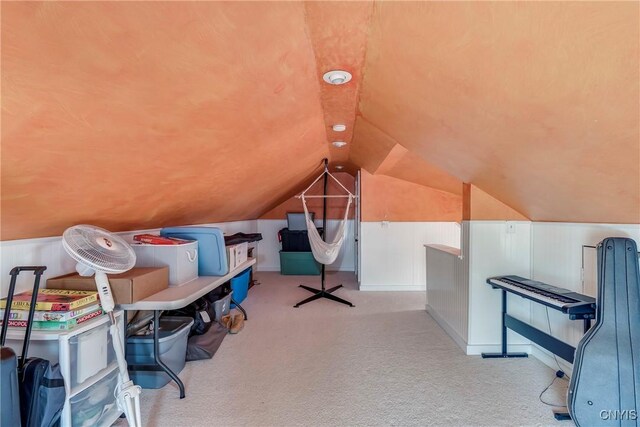 bonus room with vaulted ceiling and carpet flooring