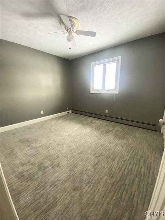 unfurnished room with ceiling fan, a textured ceiling, a baseboard radiator, and baseboards