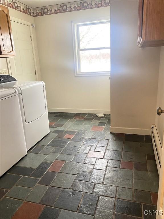 laundry area with baseboards, cabinet space, and washing machine and clothes dryer